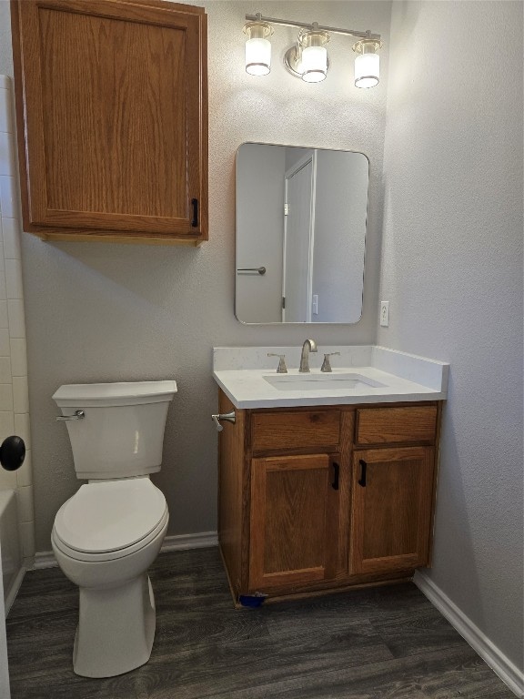 bathroom featuring hardwood / wood-style floors, vanity, and toilet