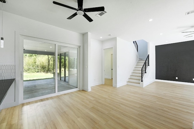 unfurnished living room with ceiling fan and light hardwood / wood-style flooring