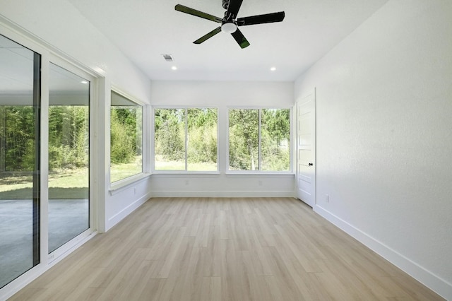 unfurnished sunroom featuring ceiling fan