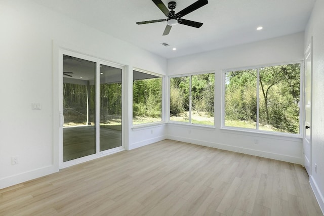 unfurnished sunroom with plenty of natural light and ceiling fan