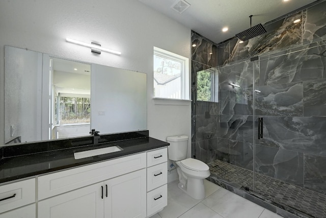 bathroom with vanity, a textured ceiling, tile patterned flooring, toilet, and a shower with shower door