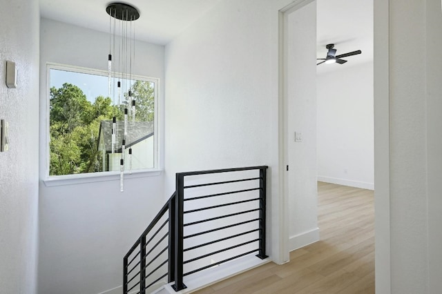 staircase featuring hardwood / wood-style flooring and ceiling fan