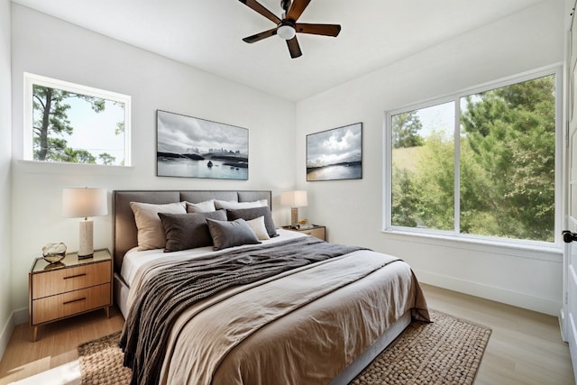 bedroom with ceiling fan and light wood-type flooring