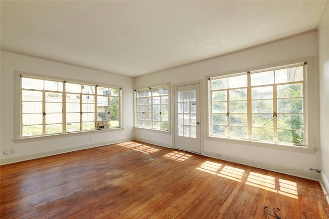 unfurnished room with hardwood / wood-style flooring and plenty of natural light