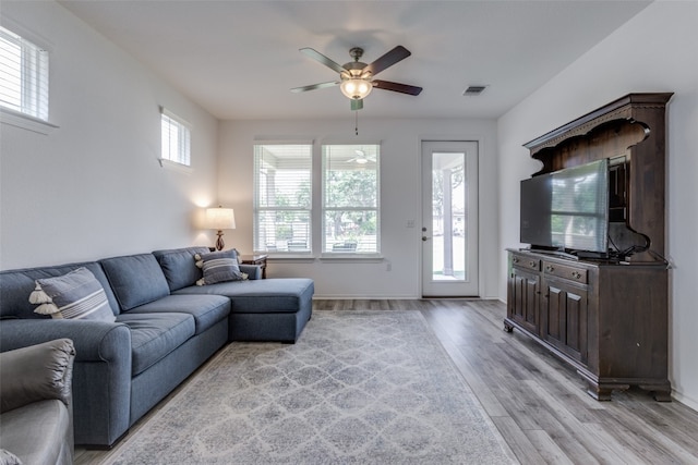 living room featuring light wood-type flooring and ceiling fan