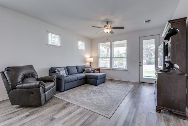 living room featuring light hardwood / wood-style floors and ceiling fan