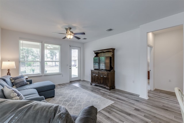 living room with ceiling fan and light wood-type flooring