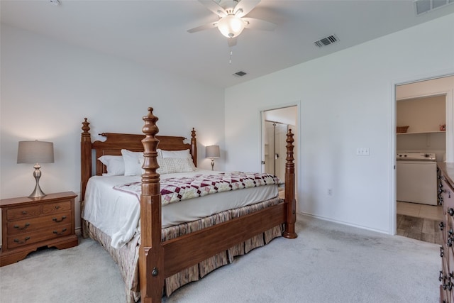 carpeted bedroom featuring washer / dryer, ceiling fan, and ensuite bath