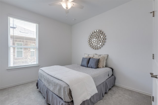 bedroom featuring ceiling fan and light colored carpet