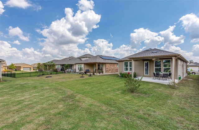 back of house featuring a yard and a patio area