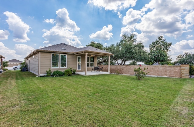 rear view of property featuring a lawn and a patio area