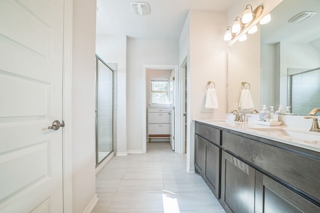 bathroom featuring vanity, an enclosed shower, and tile patterned floors