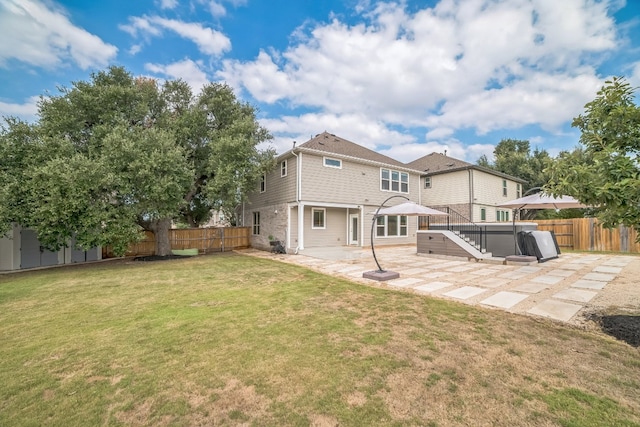 rear view of house featuring a yard and a patio