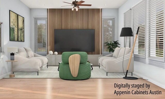 living room featuring ceiling fan and light hardwood / wood-style flooring