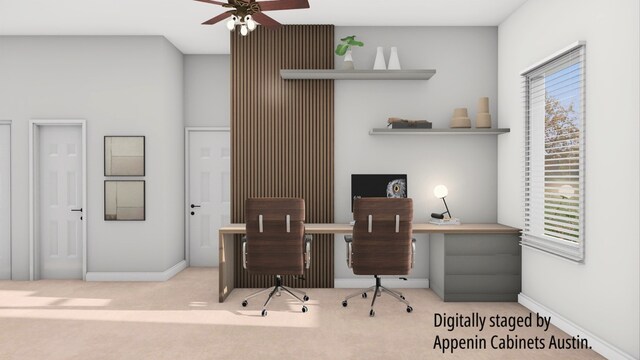 office space featuring light carpet and ceiling fan