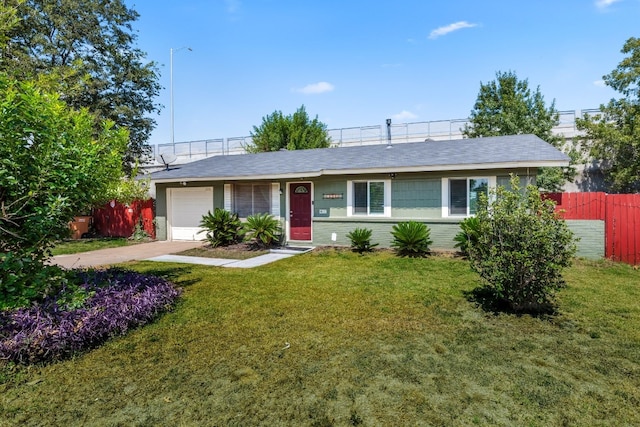 ranch-style house with a garage and a front lawn