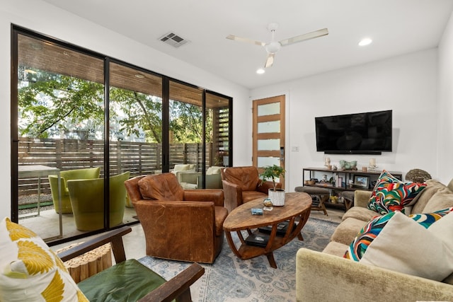 living room with a ceiling fan, recessed lighting, and visible vents