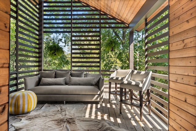 unfurnished sunroom with wood ceiling, lofted ceiling, and a wealth of natural light