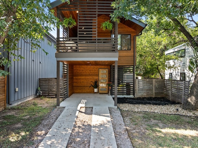 view of front of home featuring fence and stairs