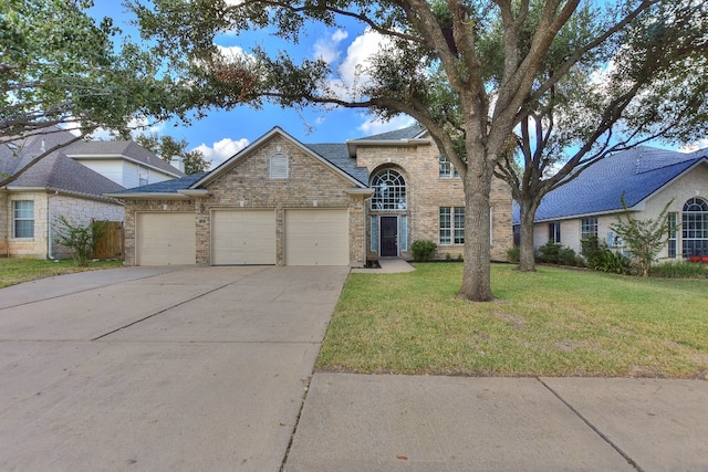 view of front of property featuring a garage and a front lawn