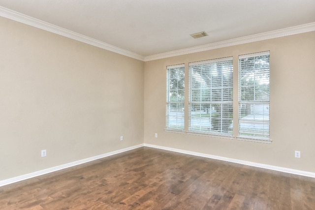 unfurnished room featuring dark wood-type flooring and crown molding