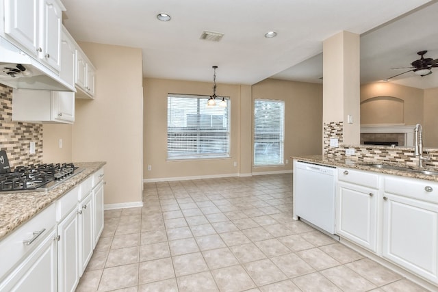 kitchen featuring ceiling fan, white cabinets, white dishwasher, sink, and tasteful backsplash