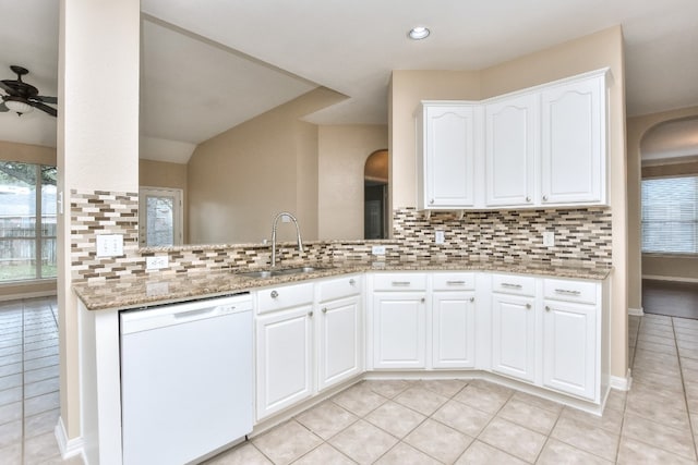 kitchen with ceiling fan, white dishwasher, tasteful backsplash, and white cabinetry