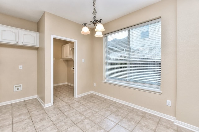 unfurnished dining area featuring a chandelier and light tile patterned floors