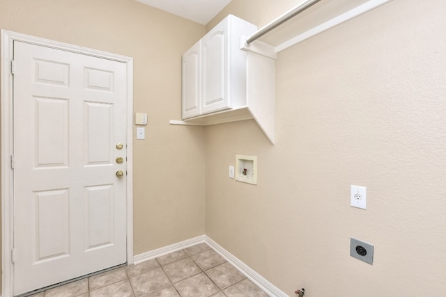 washroom featuring cabinets, electric dryer hookup, light tile patterned floors, hookup for a washing machine, and gas dryer hookup