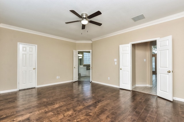 unfurnished bedroom featuring a textured ceiling, dark wood-type flooring, ensuite bath, ornamental molding, and ceiling fan