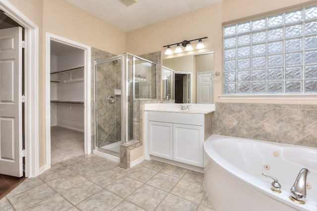 bathroom featuring vanity, separate shower and tub, and tile patterned floors