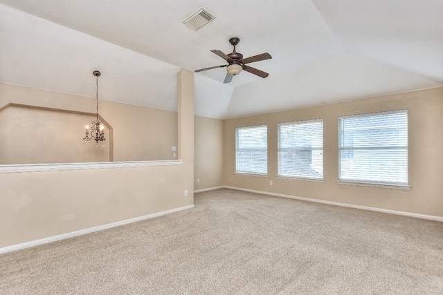 unfurnished room featuring ceiling fan with notable chandelier, lofted ceiling, and carpet flooring