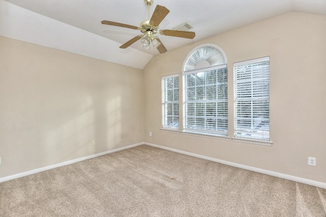 spare room featuring lofted ceiling, light carpet, and ceiling fan