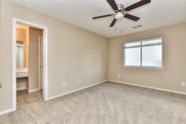 unfurnished bedroom with connected bathroom, ceiling fan, and light colored carpet