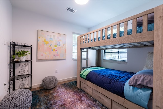 bedroom with dark hardwood / wood-style flooring