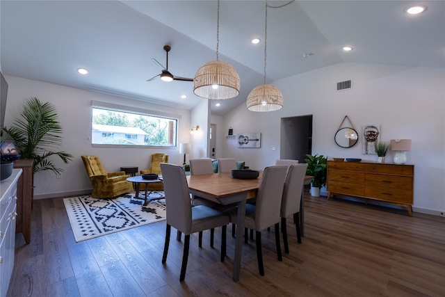 dining space with ceiling fan, dark wood-type flooring, and vaulted ceiling