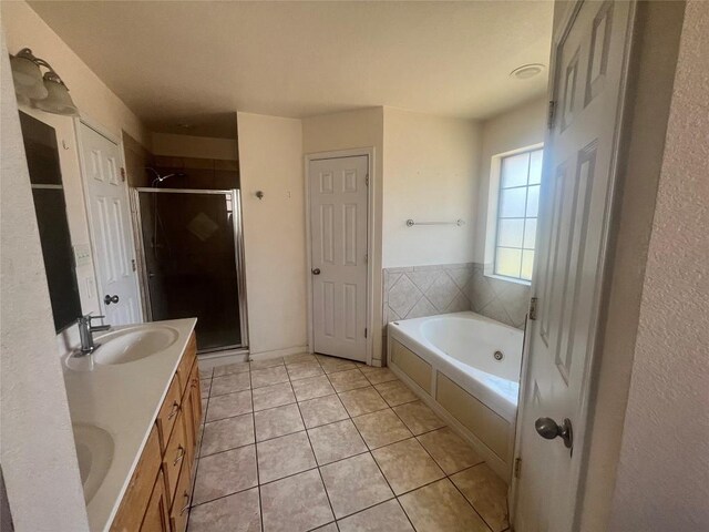 2207 Gail Dr, Copperas Cove, TX 76522 - bathroom featuring a shower stall, tile patterned floors, a bath, and double vanity