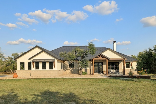 rear view of house featuring a lawn