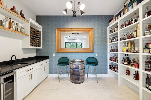 interior space with beverage cooler, wet bar, and light tile patterned flooring