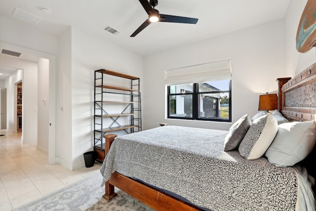 tiled bedroom featuring ceiling fan