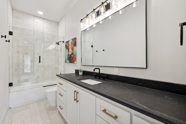 full bathroom with shower / bath combination with glass door, vanity, toilet, and tile patterned floors