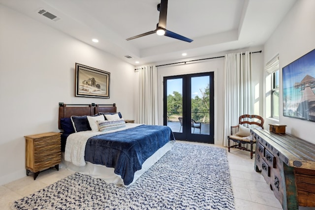 bedroom featuring a raised ceiling, ceiling fan, french doors, and access to exterior