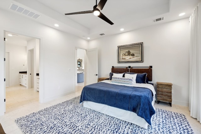 bedroom with ceiling fan, light tile patterned flooring, and ensuite bath