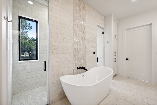 bathroom featuring independent shower and bath