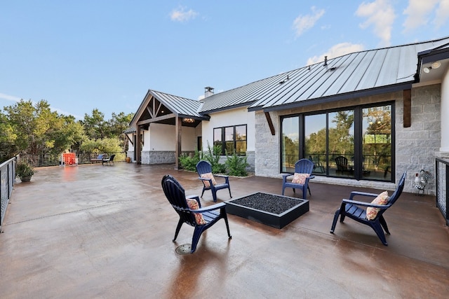 view of patio / terrace with an outdoor fire pit