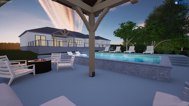 pool at dusk featuring a patio area and a fire pit