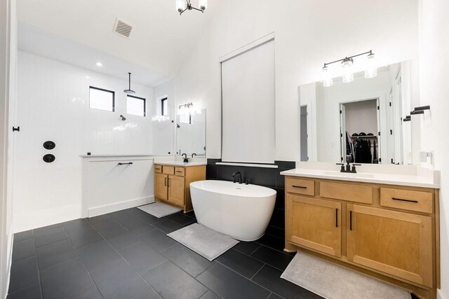 bathroom with tile patterned flooring, vanity, and independent shower and bath