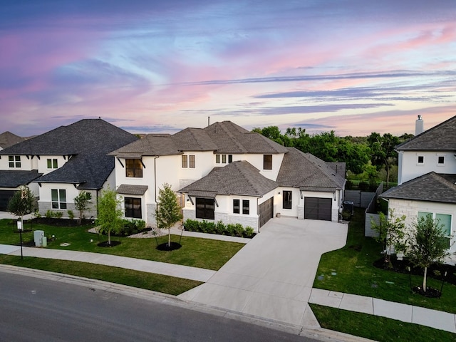 view of front facade featuring a lawn and a garage