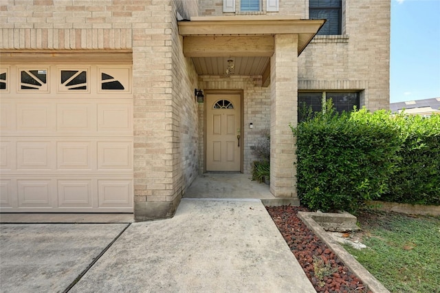 doorway to property with a garage