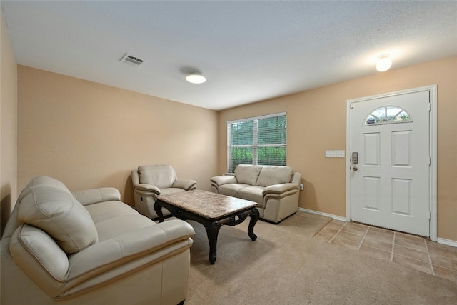 carpeted living room featuring a textured ceiling